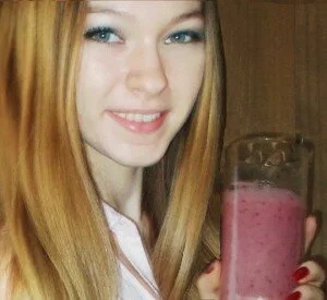 smoothie recipes for kids image of girl holding banana berry spinach drink